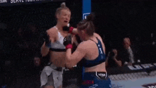 a man and a woman are wrestling in a cage .