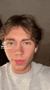 a close up of a young man 's face with a tiktok sticker on it
