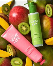 a bottle of avon beyond glow is surrounded by fruit