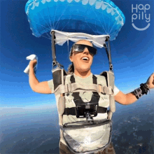 a woman wearing sunglasses and a parachute is flying in the air with hap pillu written on the bottom
