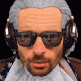 a man wearing sunglasses and headphones has a reflection of another man 's face