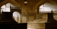 a very ornate room with a staircase and a lantern hanging from the ceiling and a few windows