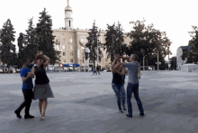 a group of people dancing in front of a building that says pepsi