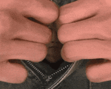 a close up of a person 's hands opening a zipper on a pair of jeans