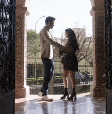 a man and a woman standing next to each other in a doorway