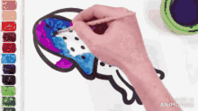 a person is painting a jellyfish on a white paper