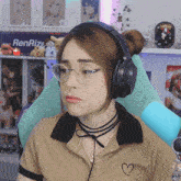 a woman wearing glasses and headphones is sitting in front of a wall that says renrize
