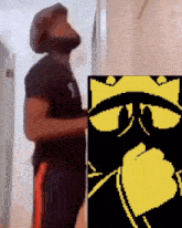 a man with a beard is standing next to a picture of a cat with a crown