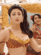 a woman in a crop top is dancing in front of a crowd .
