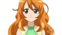 a girl with long orange hair and a green shirt is looking at the camera with an angry look on her face .