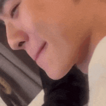 a close up of a person 's face with their eyes closed .