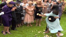 a woman in a blue dress is dancing with a man in a black hat