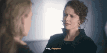 two women are talking to each other and one of them is saying `` hey , poppins '' .