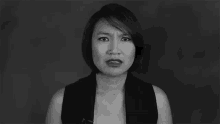 a black and white photo of a woman making a serious face