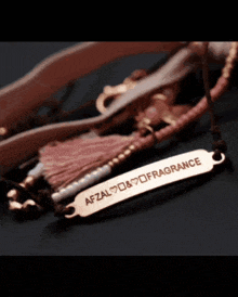 a close up of a bracelet with the word fragrance on it