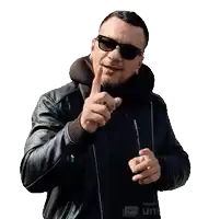 a man wearing sunglasses and a leather jacket is pointing at the camera