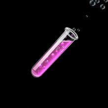 a test tube filled with purple liquid and bubbles coming out of it