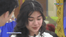 a man and a woman are looking at each other with the caption #pbbadultcrushkita on the bottom