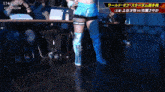a female wrestler stands in front of a stardom sign