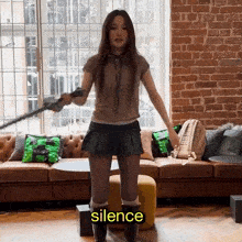 a woman standing in front of a couch with the word silence on the bottom