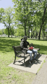 a man sits on a bench reading a book