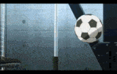 a soccer ball is going through a fence with a stool in the foreground