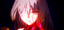 a close up of a girl with a red flower in her hand