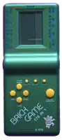 a green brick game e-576 is displayed