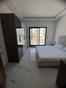 a bedroom with a sliding glass door and a bed