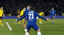 a soccer player with the number 21 on the back of his shirt
