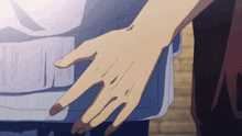 a close up of a person 's hand touching another person 's back