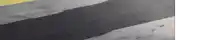 a close up of a shadow of a person walking on a street .
