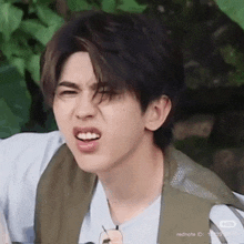 a close up of a person making a funny face with their mouth open .