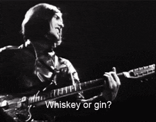 a man singing and playing a guitar with the words whiskey or gin written below him