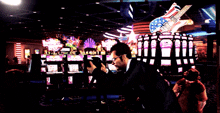 a man in a suit and sunglasses stands in front of a casino