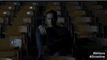 two men are talking in an empty stadium with # billions showtime written on the bottom