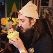 a man with a beard wearing a beanie with the word goku on it