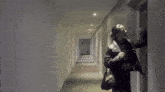 a woman is standing in a hallway with a purse