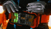a person wearing gloves is holding a device that says ' i 'm a robot ' on it