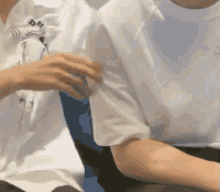 a close up of a person 's arm with a white shirt on