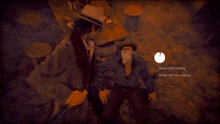 a man in a hat is standing next to another man who is laying on the floor
