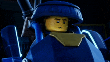 a lego character is sitting on top of a blue object