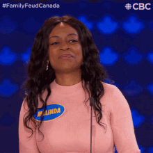 a woman in a pink sweater has a name tag that says melinda