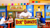 a bob 's burgers restaurant with a chef holding a sandwich