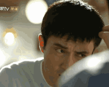 a close up of a man 's face with the word tv on the bottom