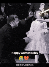 a black and white photo of a little girl with the words happy women 's day below it