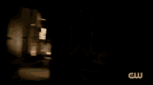 a man is fighting another man with a sword in a dark alleyway .