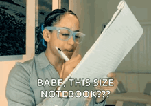 a woman wearing glasses is writing on a piece of paper with the words babe this size notebook on the bottom