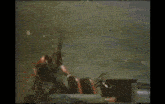 a blurry picture of a man holding a gun with the words ya above him