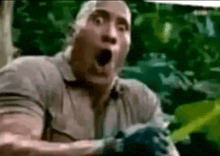 a man with a surprised look on his face is standing in the jungle .